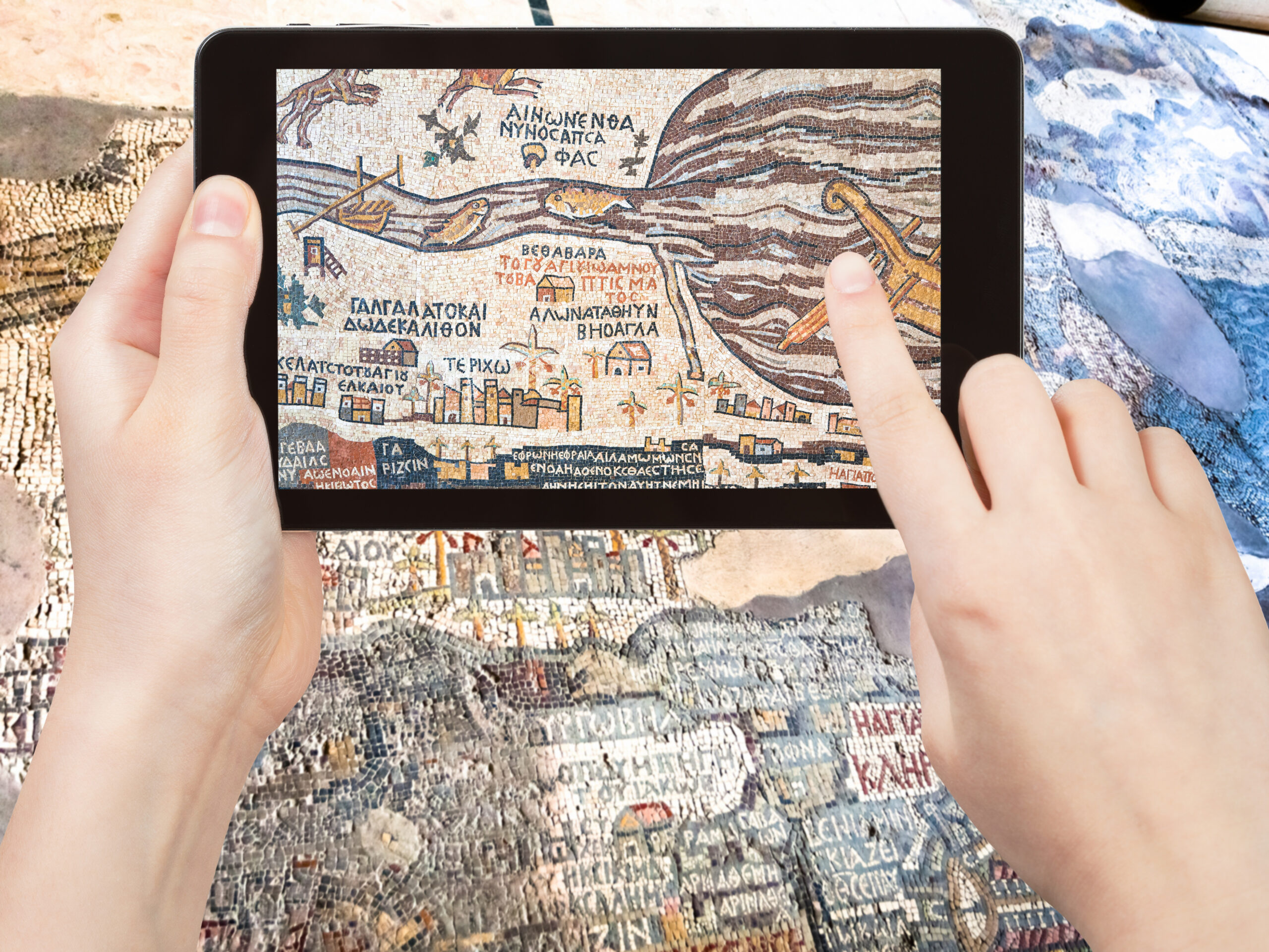 travel concept - tourist shoots photo of ancient byzantine map of Holy Land, Madaba on smartphone, Jordan